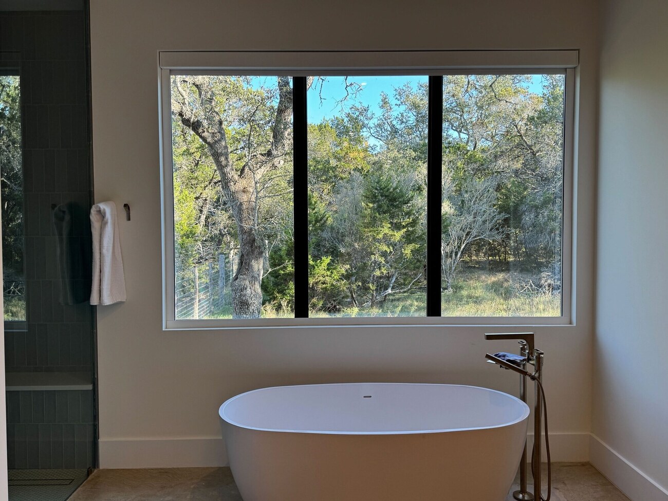 Primary bath with freestanding tub and picture window