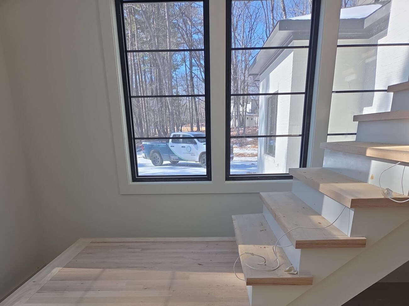 Floating staircase during rough-in with exposed low-voltage LED wiring