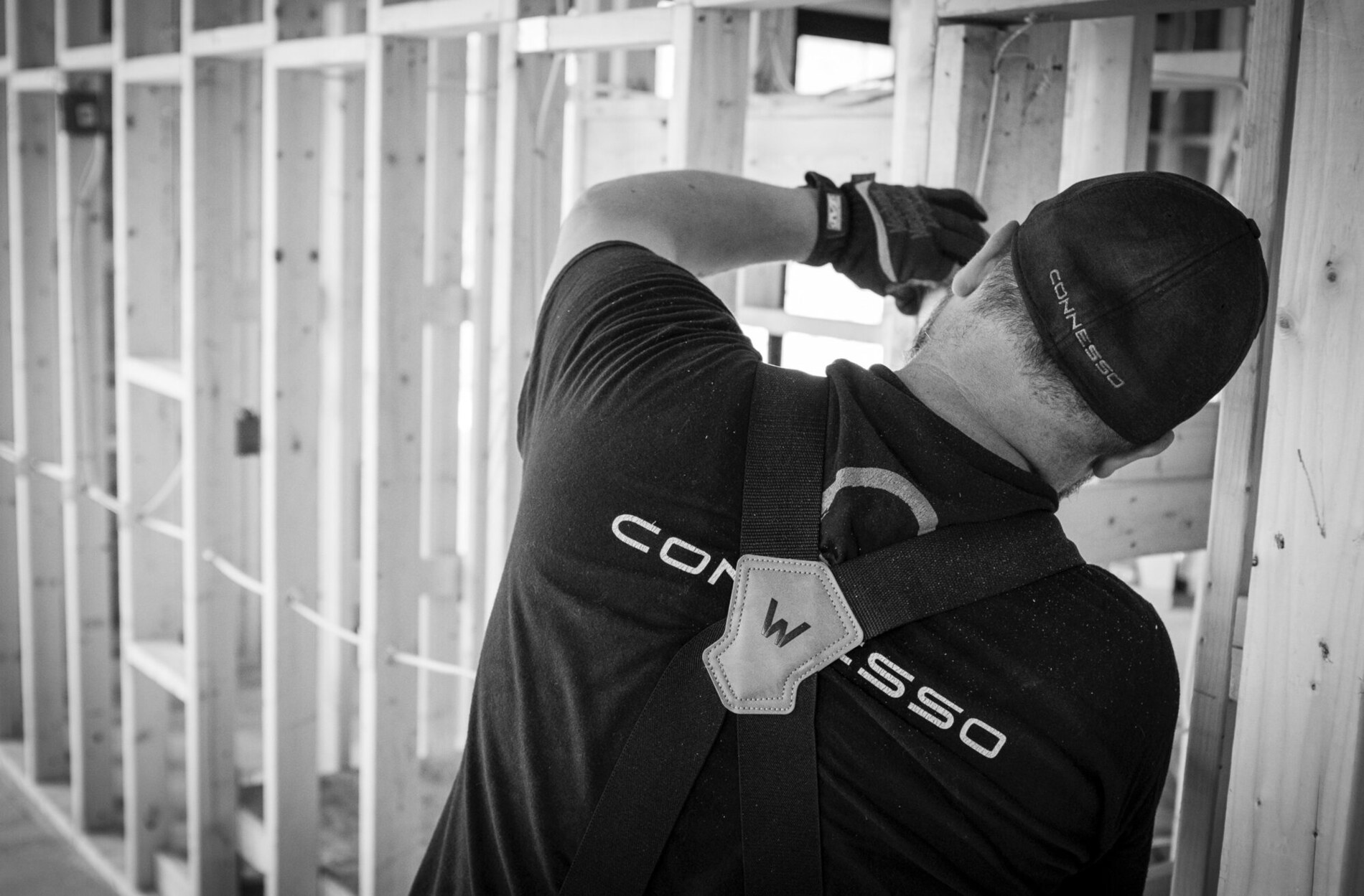 Connesso technician working at a wood-framed jobsite during rough-in