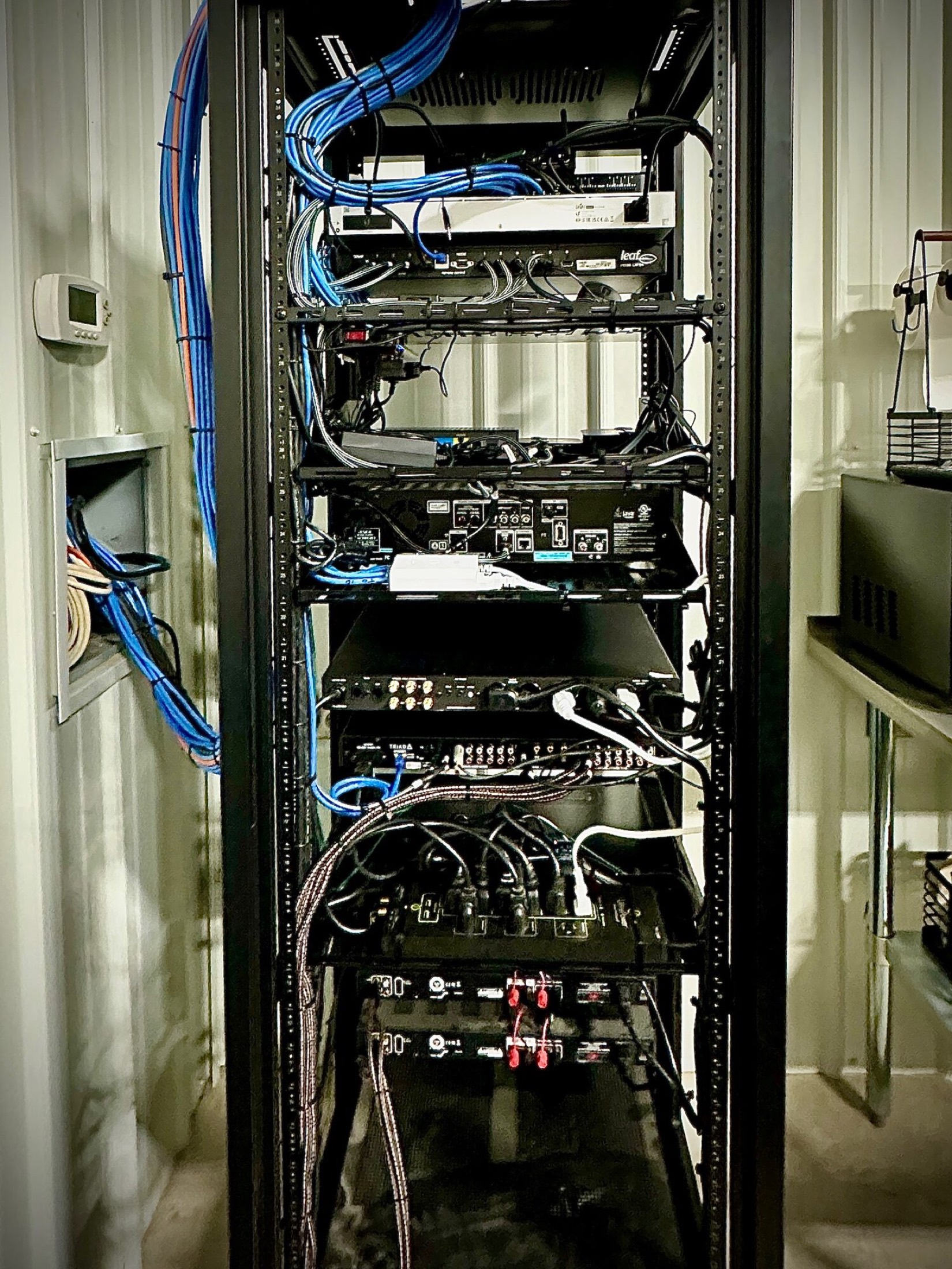 Equipment rack with labeled structured wiring and network gear during installation