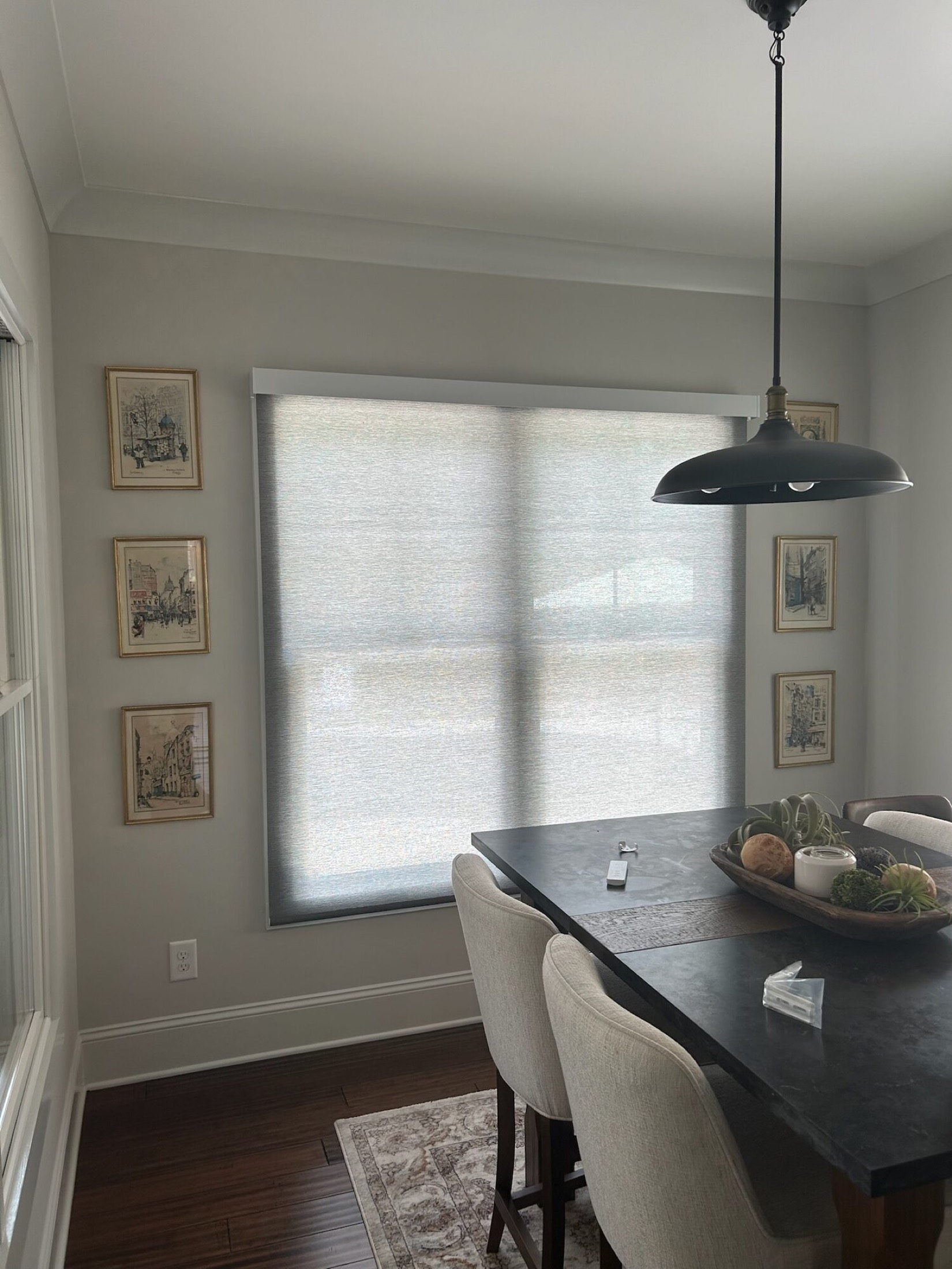 Motorized roller shade under Control4 control in a sunlit dining nook