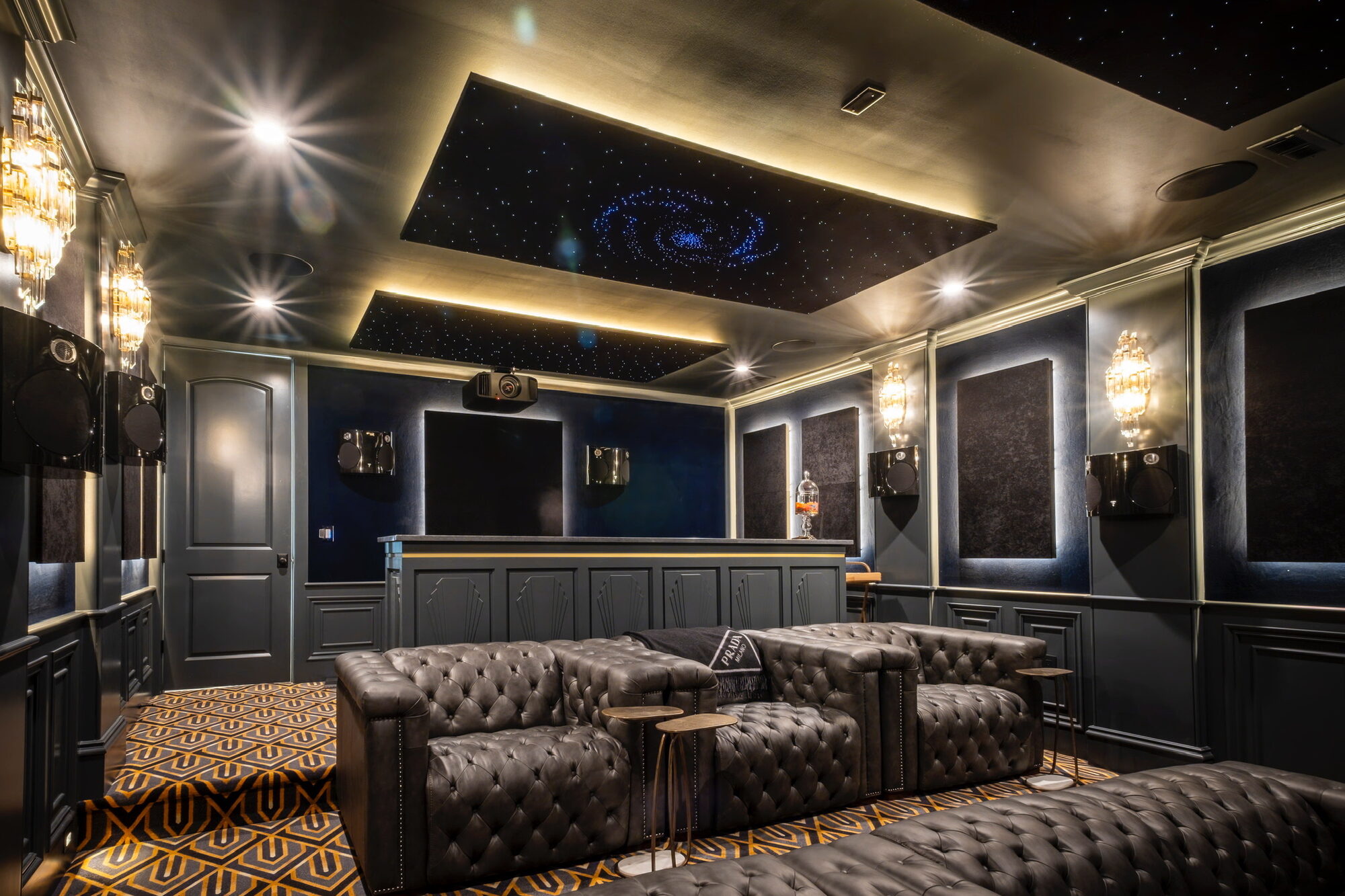 Tiered tufted leather theater seating under a fiber-optic star ceiling in a Galena, Ohio home cinema