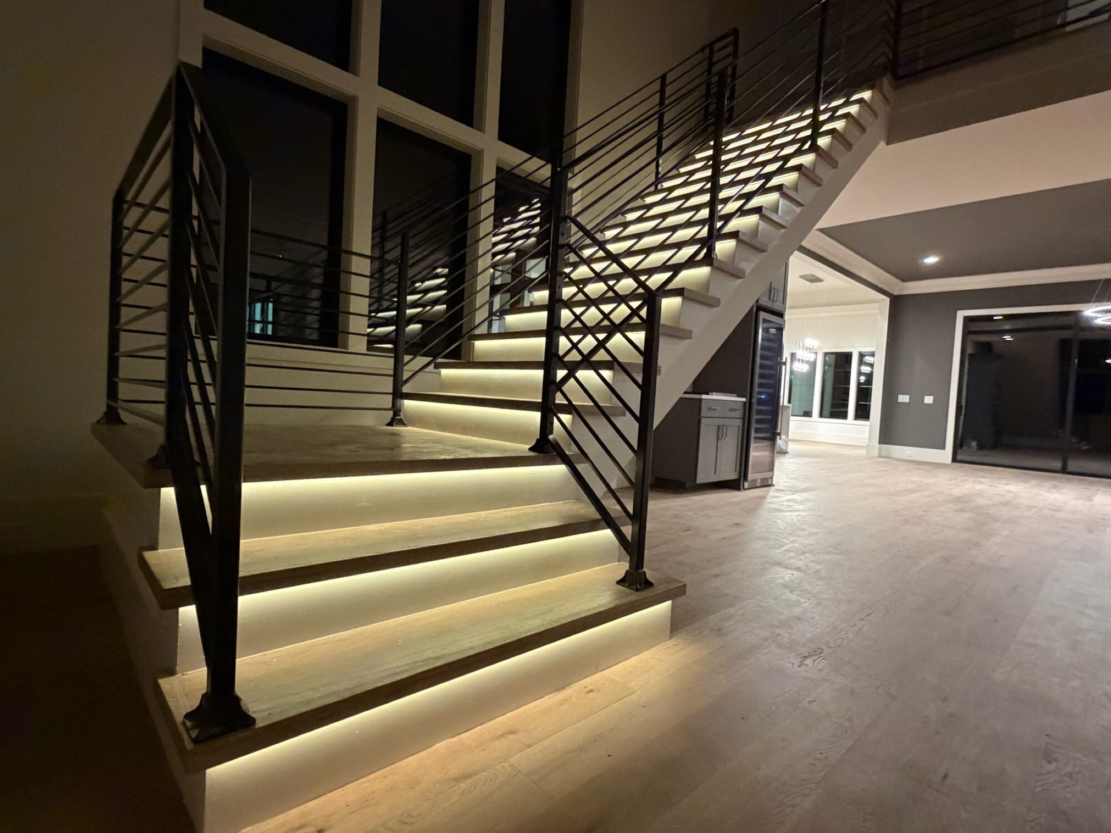 Floating staircase with LED under-tread lighting dimmed by a Josh.ai goodnight command