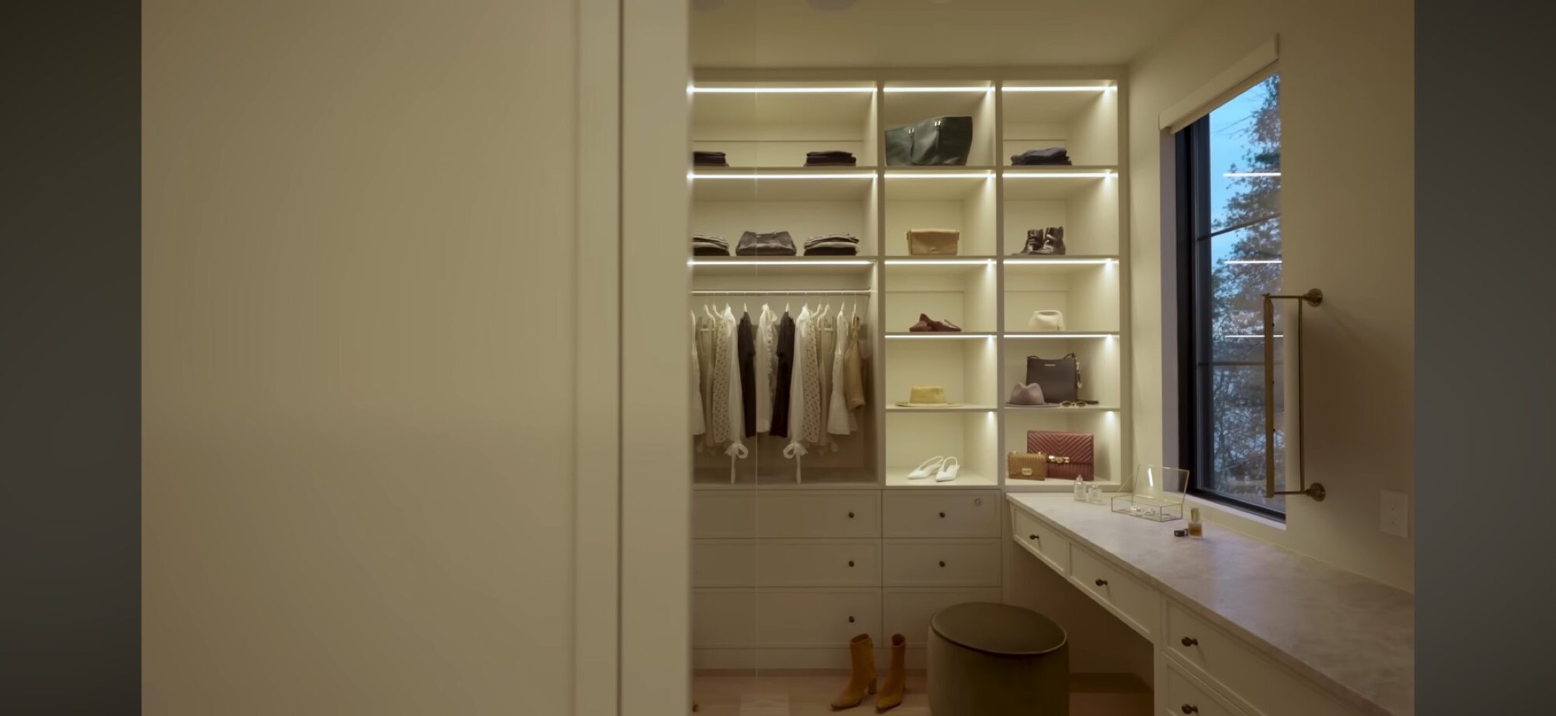 Walk-in closet with integrated LED shelf lighting on a Josh.ai morning voice control scene