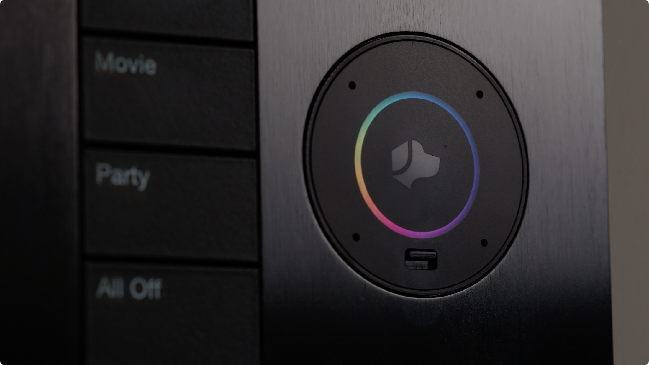 Close-up of a black Lutron Palladiom keypad with engraved scene buttons and a glowing color dial