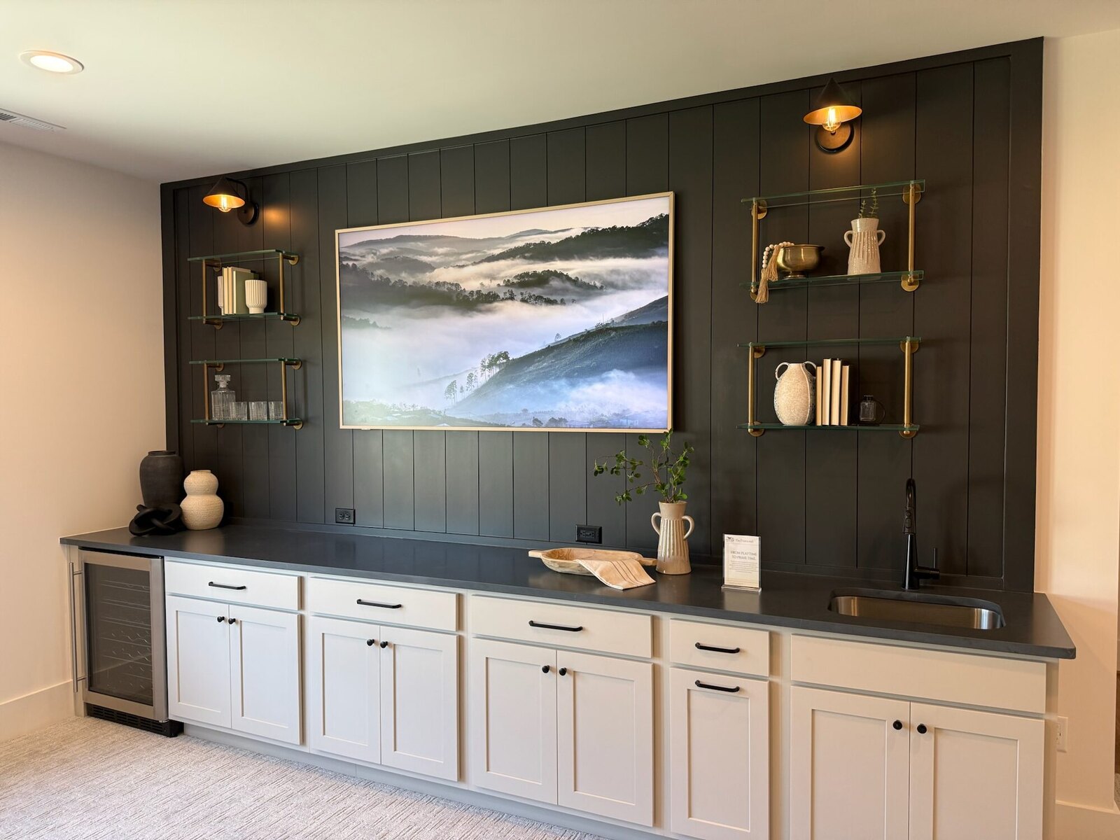 Samsung Frame TV in art mode above a wet bar with brass shelving, Worthington OH
