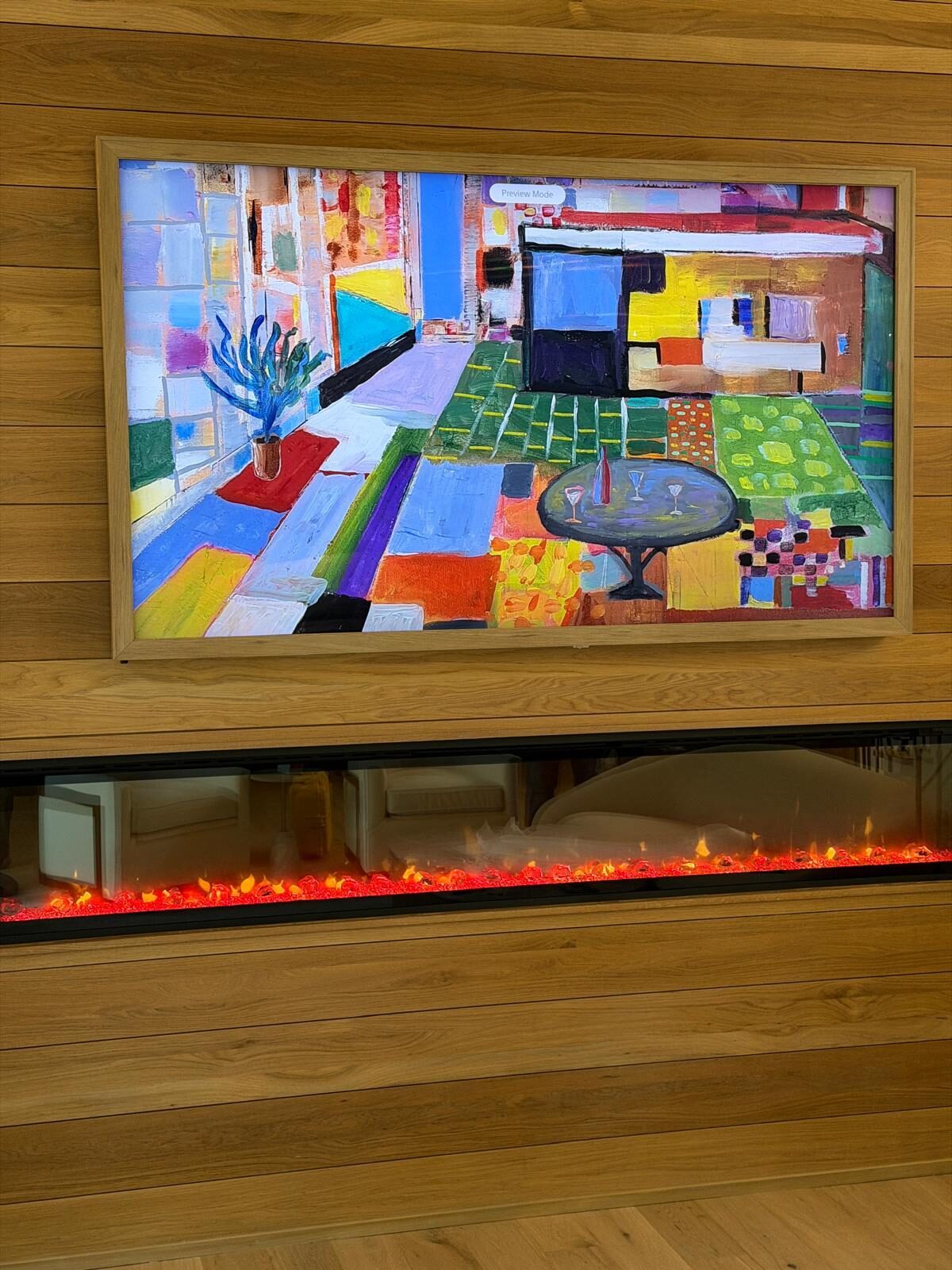 Samsung Frame TV in art mode on white oak paneling above a glowing linear fireplace, Holly Springs NC