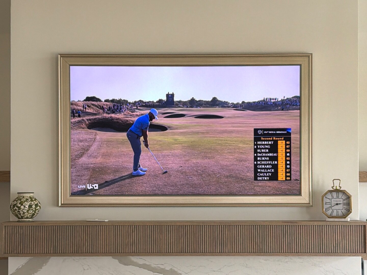 Samsung Frame TV in art mode above a linear fireplace with marble surround, Seven Lakes NC