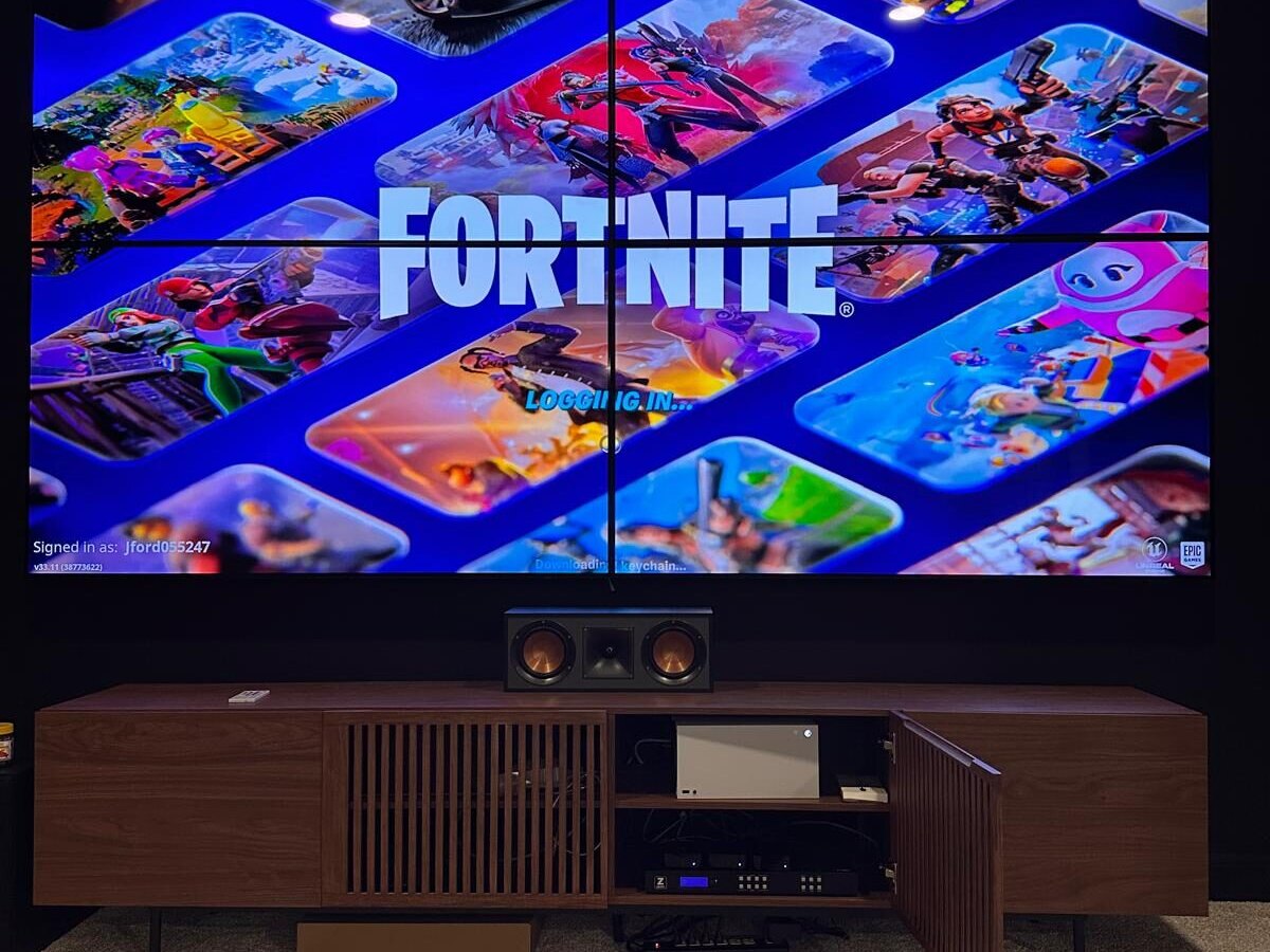 Four panel video wall above a walnut media console, Westerville OH