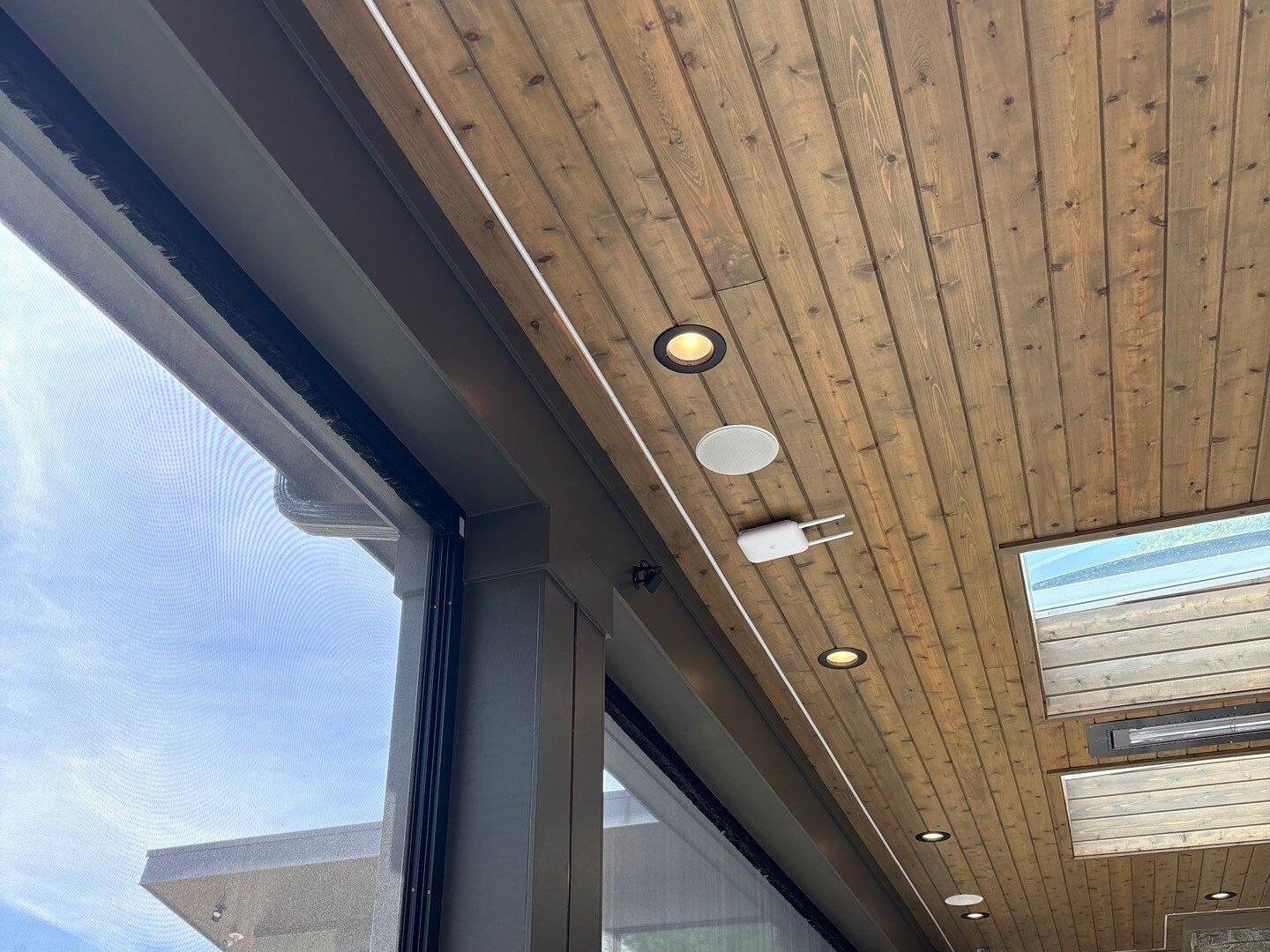 Wireless access points and recessed lighting installed in a wood plank porch ceiling, Pittsboro NC